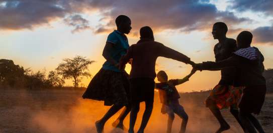 Vimbainashe and Phanuel are playing a game with their friends just outside their home in Chadanyika village