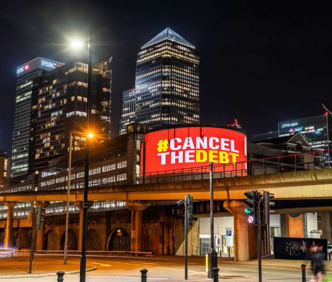 "Cancel the debt" displayed on an electronic billboard