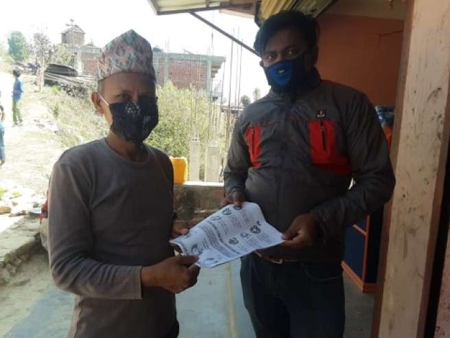 Jeewan Silwal, from Christian Aid partner FOCUS Nepal, handing out leaflets to vulnerable communities about Covid-19 as part of awareness raising work.