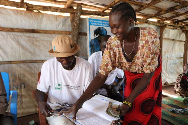 Elizabeth receives her share from the Village Savings and Loans Association in South Sudan 