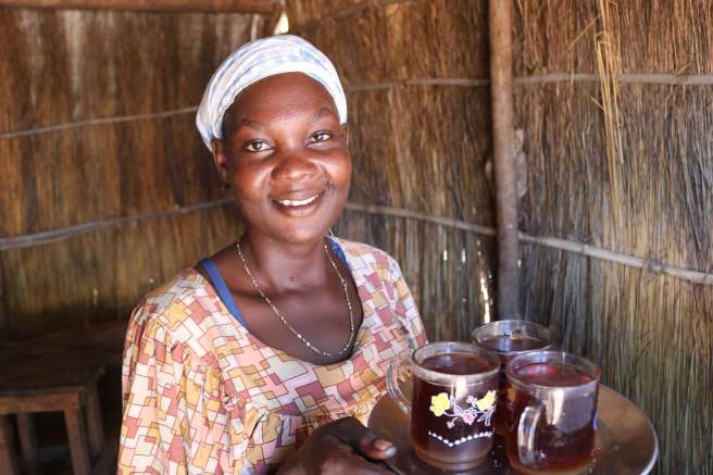 Elizabeth serves tea to her customers in her new tea shop in South Sudan 