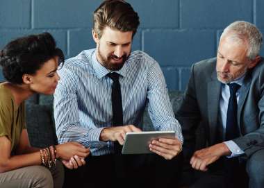 Three business leaders sit and look at a screen as members of the Salt Business Network