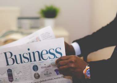 Person reading a business newspaper